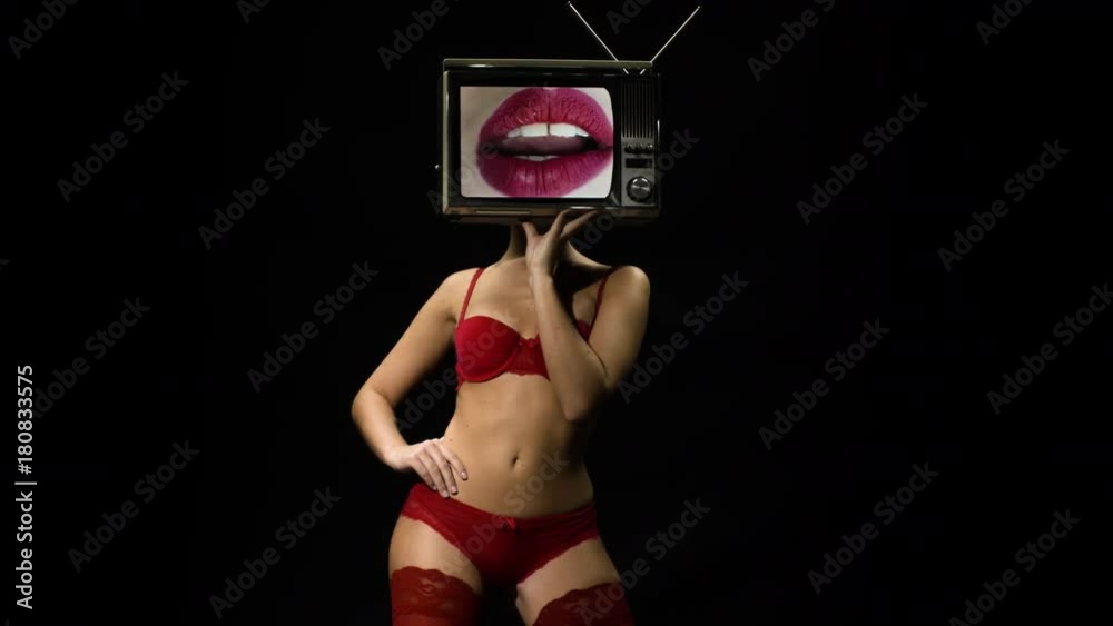 amazing woman in red lingerie dancing and posing with a television as a  head. the tv is has video of lips moving