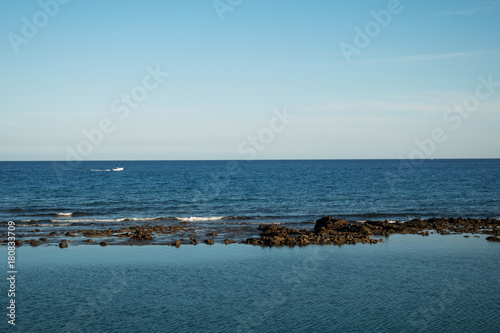 Atlantic ocean with rocks and boat behind  © Stanislav
