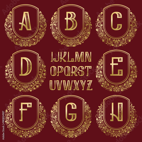 Patterned royal monogram kit. Golden letters and ornamental circular wreath frames for creating initial logo in vintage style.