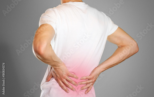 Wallpaper Mural A man holds back. Pain in the lower back. Andros. Sore point highlighted in red. Closeup. Isolated Torontodigital.ca
