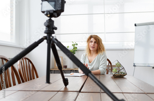 Picture of florist girl with florarium on table. photo