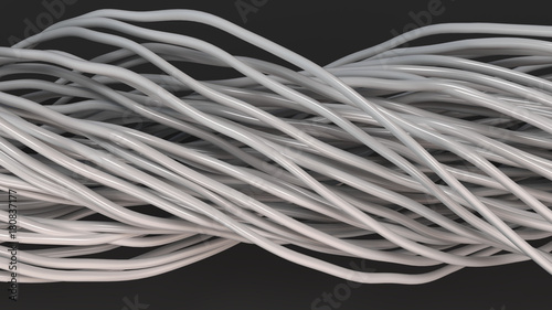 Twisted white cables and wires on black surface