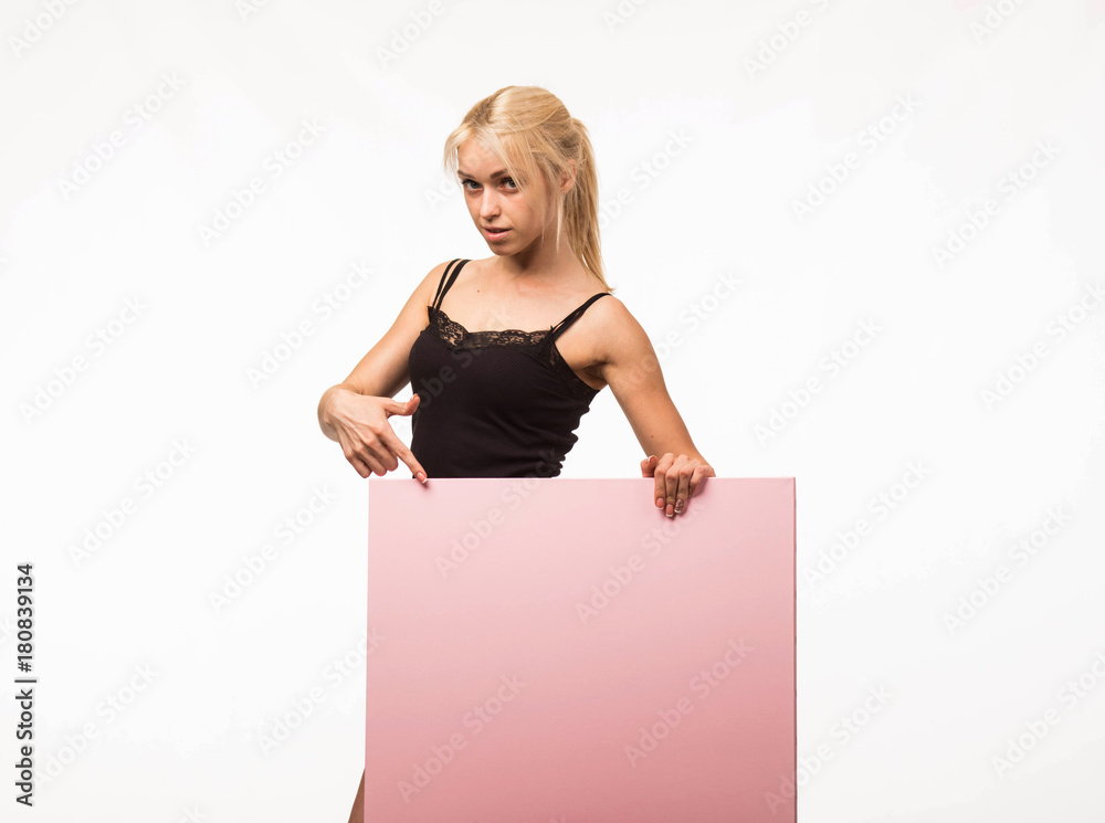 Young sexy woman portrait of a confident businesswoman showing presentation, pointing placard gray background. Ideal for banners, registration forms, presentation, landings, presenting concept. Young sexy woman portrait of a confident businesswoman showing presentation, pointing placard gray background. Ideal for banners, registration forms, presentation, landings, presenting concept.