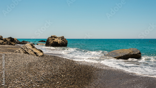 Pissouri Bay pebble beach with large rocks in a sea, Cyprus