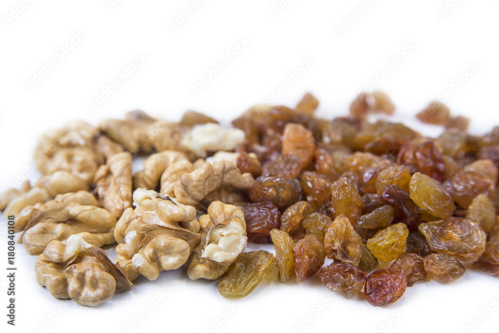 Raisins and walnuts bake ingredients on the white background Raisins and walnuts bake ingredients on the white background