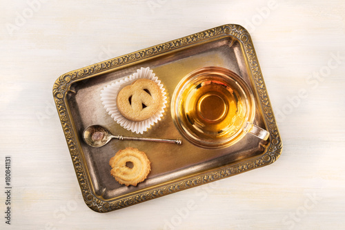 Danish butter cookies and tea on vintage tray with copyspace