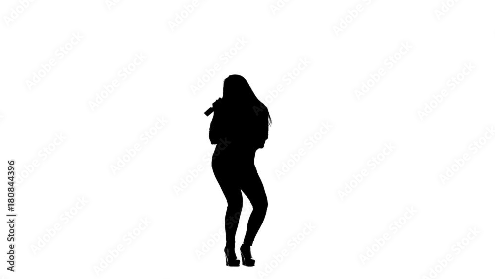 Girl sings incendiary songs into the microphone. White background. Silhouette. Slow motion Girl sings incendiary songs into the microphone. White background. Silhouette. Slow motion