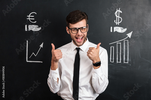 Happy attractive businessman in white shirt showing thumb up gesture with two hands