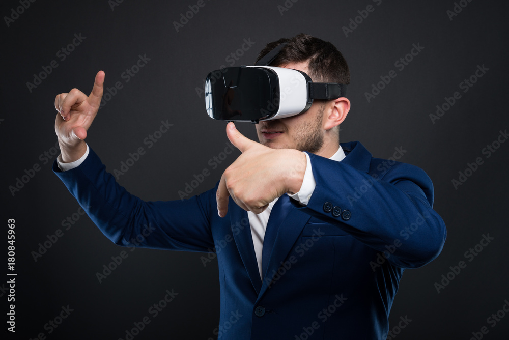 Young man using VR glasses for videogame Young man using VR glasses for videogame