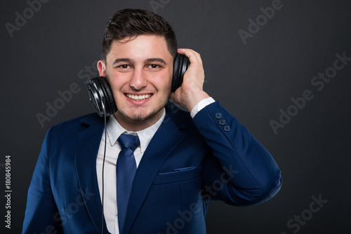 Cheerful ceo posing with modern headphones
