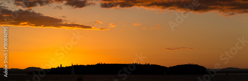 Very large horizontal panoramic orange sunset on Trasimeno Lake (Umbria, Italy)