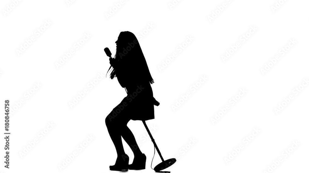 Fiery singer sings rock and roll songs. White background. Silhouette. Slow motion Fiery singer sings rock and roll songs. White background. Silhouette. Slow motion