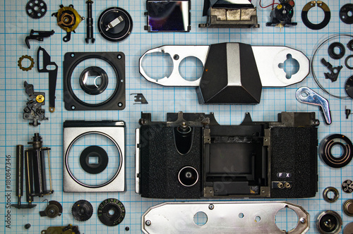 parts old retro film SLR camera on graph paper