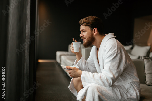 Handsome man relaxing drinking tea