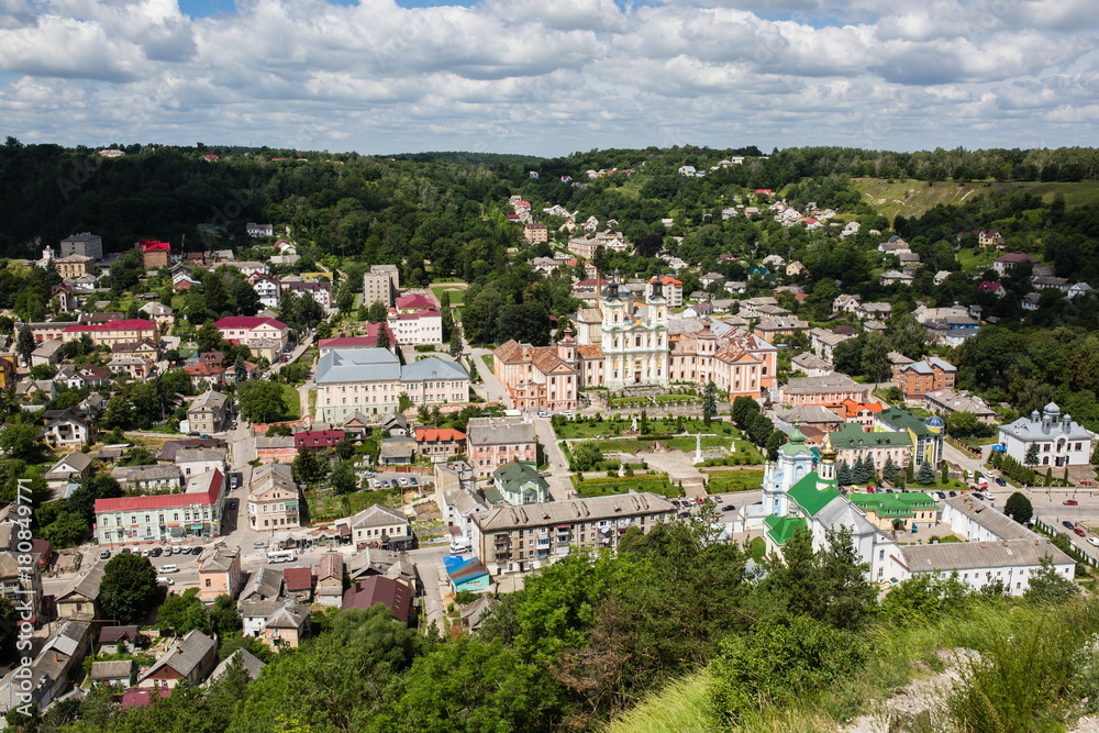 Top aerial city landscape close up view. Kremenets, Ukraine. Old buildings with peeling paint. Beautiful churches Baroque style and green park Top aerial city landscape close up view. Kremenets, Ukraine. Old buildings with peeling paint. Beautiful churches Baroque style and green park