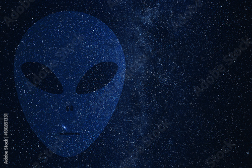 Alien face silhouette on background of Universe. Space sky in the night.
