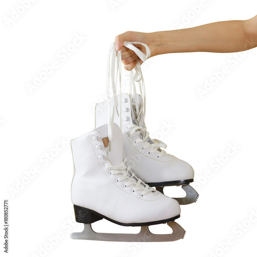 Hand holding woman ice skates isolated on a grey background