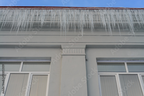 Bottom view of the building cover with hanging icicles