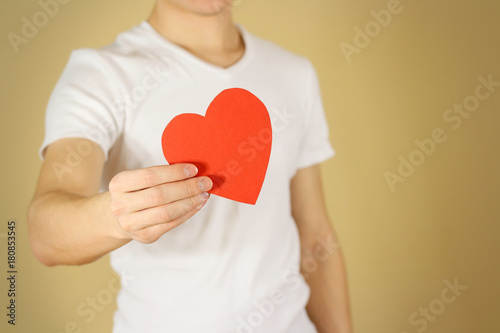 Man hands holding blank empty red Valentines card with heart on a white background