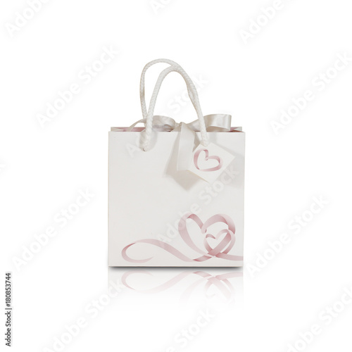 Blank white paper gift bag mock up standing on isolated white background. Empty plastic package mockup stand on table isolated. Consumer pack ready for logo design or identity presentation.