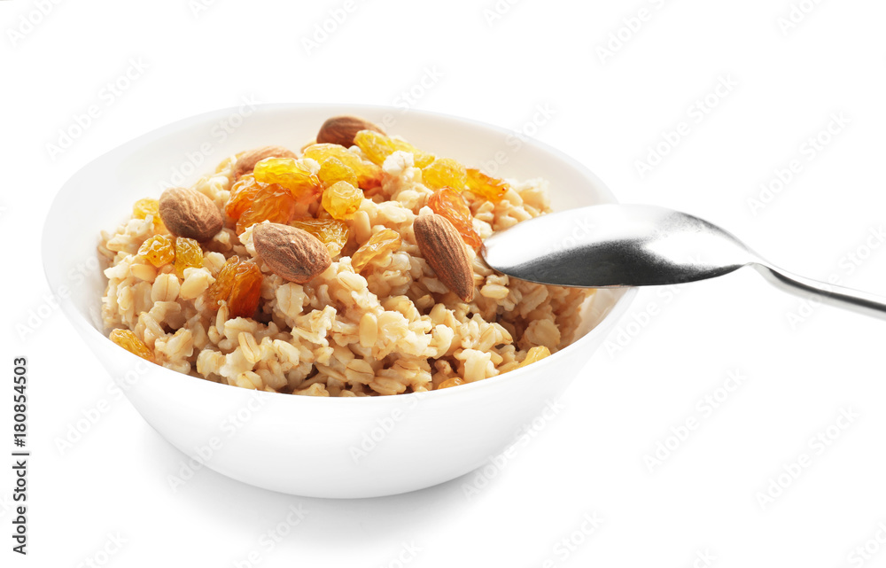 Tasty oatmeal with raisins and almond in bowl on white background Tasty oatmeal with raisins and almond in bowl on white background