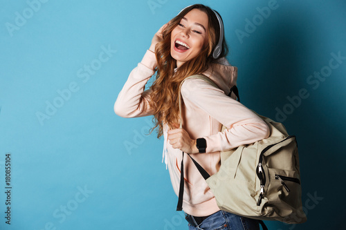 Portrait of a lovely happy girl student with backpack