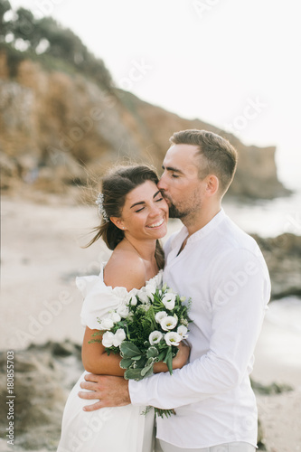 A loving couple is walking on the beach