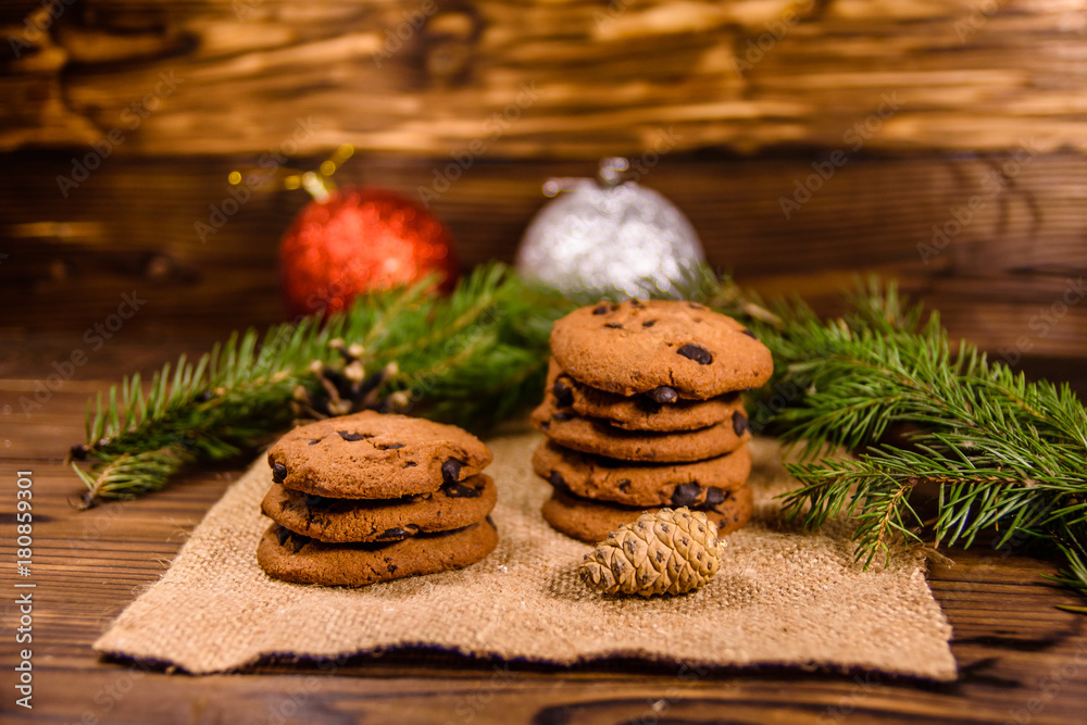 Chocolate chip cookies and christmas decorations on a wooden table