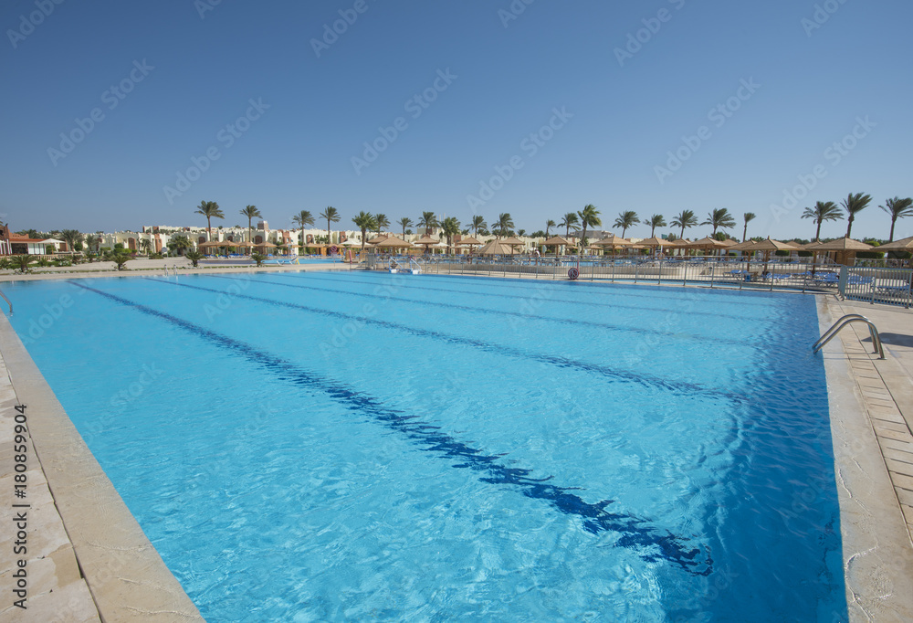 Large sports swimming pool in a luxury tropical hotel resort