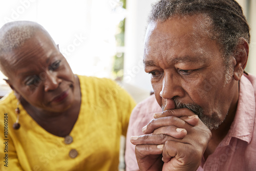 Senior Woman Comforting Man With Depression At Home photo