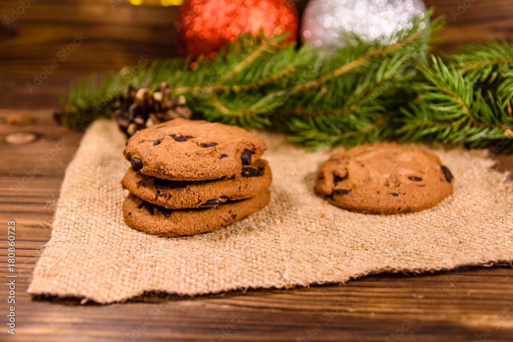 Chocolate chip cookies and christmas decorations on a wooden table Chocolate chip cookies and christmas decorations on a wooden table