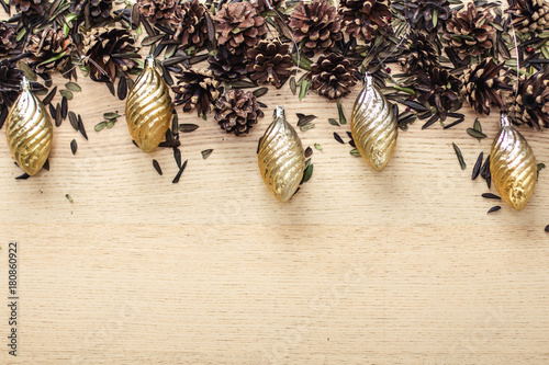 Foto cones and fur-tree toys with leaves on a wooden background