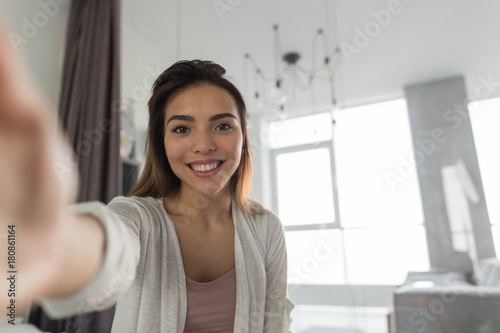 Beautiful Girl Taking Selfie Portrait Photo In Bedroom In Morning Happy Smiling In Camera photo