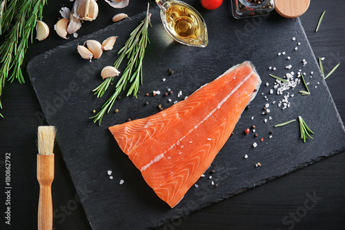 Composition with salmon fillet and ingredients for marinade on table