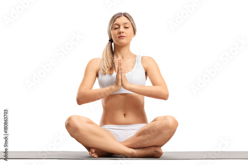 Young woman meditating on an exercise mat