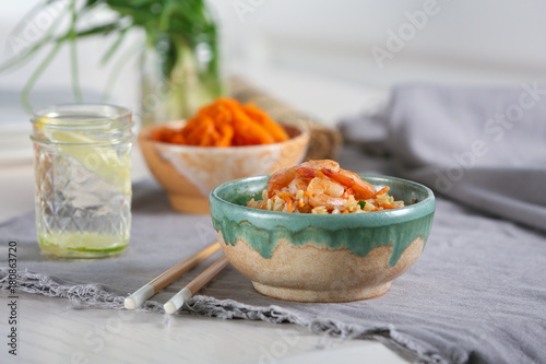 Bowl with delicious shrimp fried rice on table