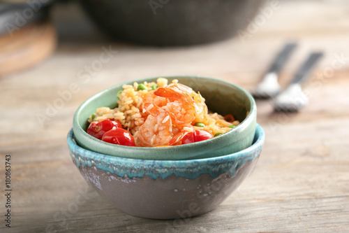 Bowls with delicious shrimp fried rice on table