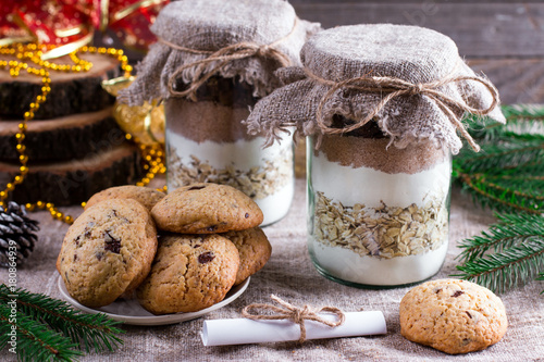 Fototapeta A stack of cookies and cookie mix in a jar, concept Christmas and holiday