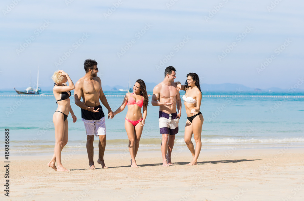Young People Group On Beach Summer Vacation, Happy Smiling Friends Walking Seaside Sea Ocean Holiday Travel Young People Group On Beach Summer Vacation, Happy Smiling Friends Walking Seaside Sea Ocean Holiday Travel