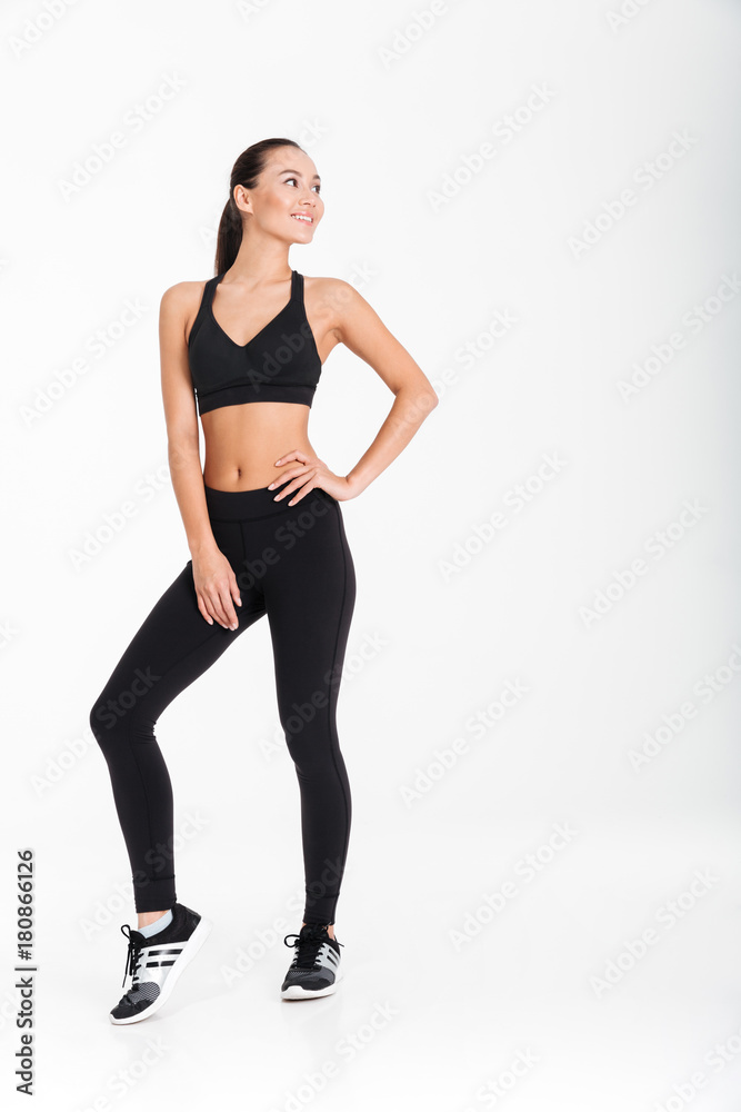 Happy young sports lady posing isolated