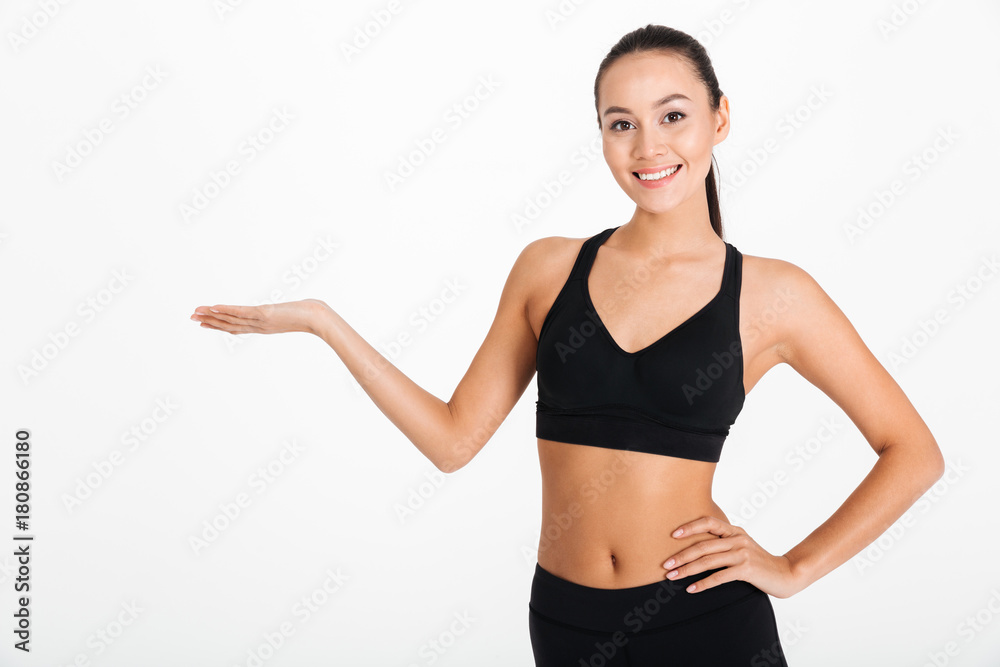 Beautiful young sports woman holding copyspace. Beautiful young sports woman holding copyspace.