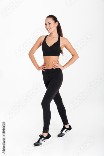 Happy young sports lady posing isolated