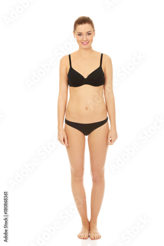 Happy woman standing in bikini.