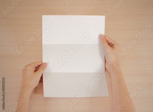 Hands holding blank white brochure booklet in the hand. Leaflet presentation. Pamphlet hand man. Show offset paper. Sheet template. Book in hands. Booklet folding design. Fold paper sheet display read © OB production