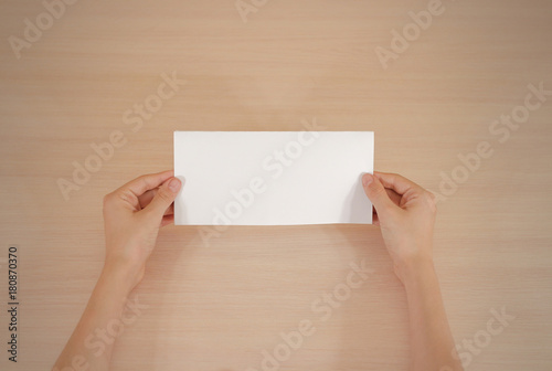 Hands holding blank white brochure booklet in the hand. Leaflet presentation. Pamphlet hand man. Show offset paper. Sheet template. Book in hands. Booklet folding design. Fold paper sheet display read
