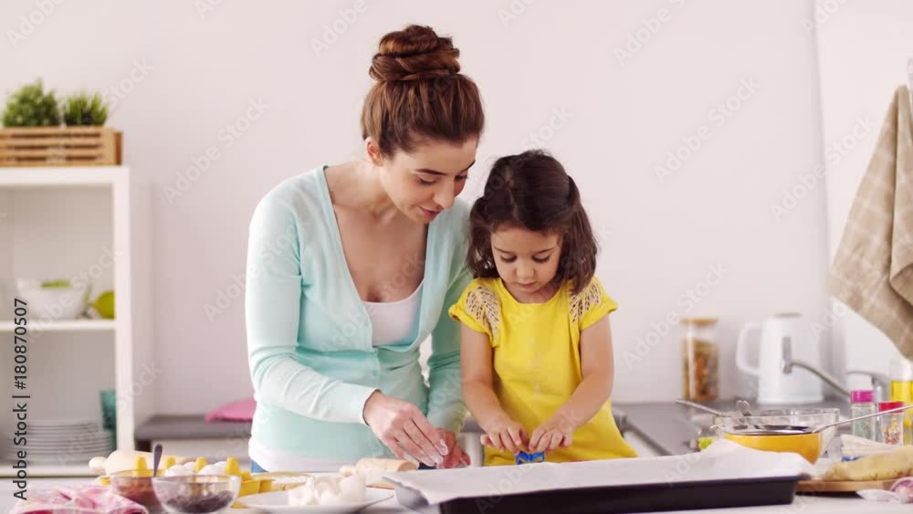 happy mother and daughter making cookies at home happy mother and daughter making cookies at home
