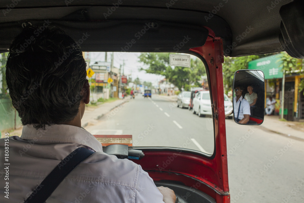 Fototapeta premium A tuk tuk driver on the road