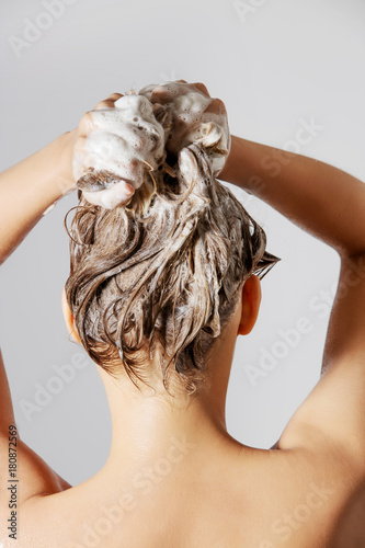 Woman washing her blond hair