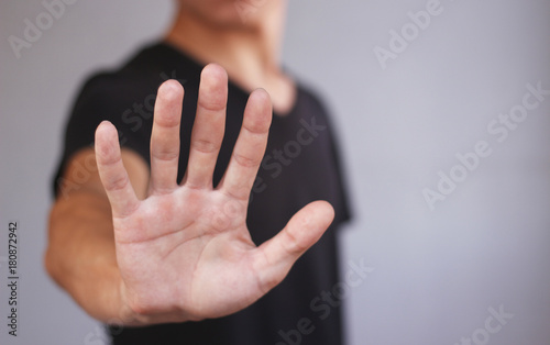 Young man in black t shirt shows his hand