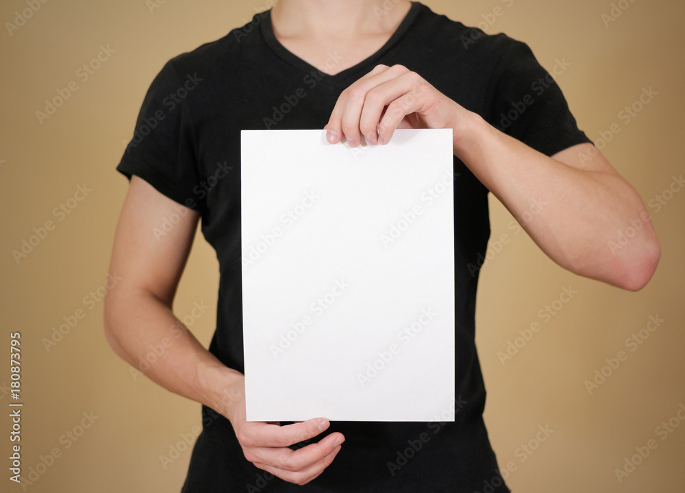 Man showing blank white big A2 paper. Leaflet presentation. Pamp Stock  Photo by ©onlyblacktv.bk.ru 146432985